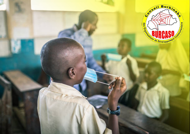 African  teacher and her students wearing protective face mask at the elementary school after covid-19